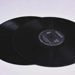 Close-up of two classic vinyl records on a flat surface, showcasing grooves.